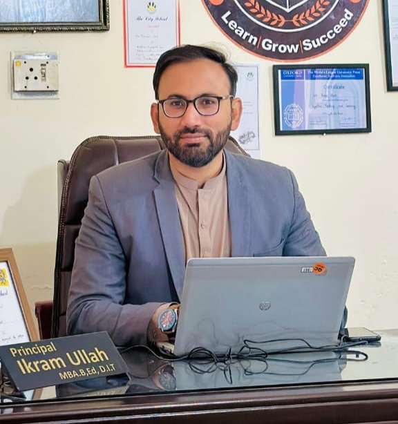 Principal Ikram Ullah at his desk